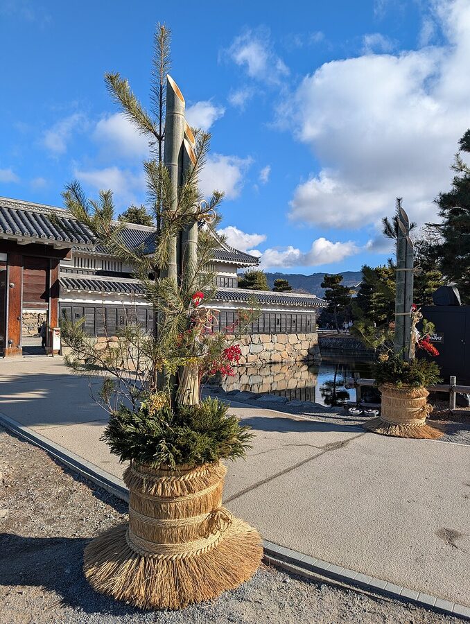 Matsumoto Castle with large traditional kadomatsu pine-and-bamboo New Year decorations placed at the Kuromon gate entrance on 4 January 2025