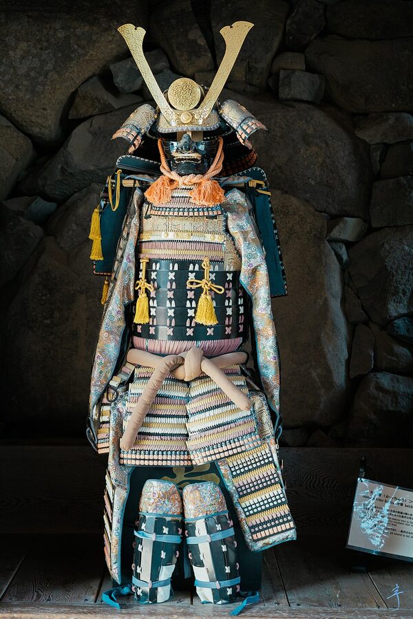 Suit of samurai armor on display inside one of the upper floors of Matsumoto Castle tenshu as part of the castle museum collection of Edo-period arms and armor