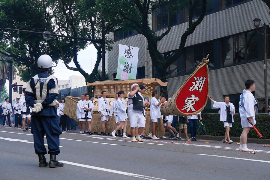 A wooden shoro-bune spirit boat being carried through the streets of Nagasaki during the shoro nagashi procession