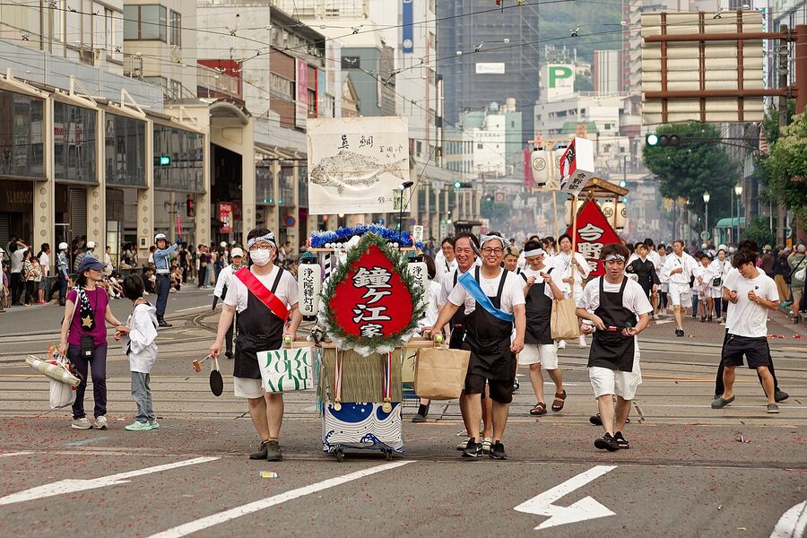 The Nagasaki shoro nagashi procession on 15 August 2024 with families carrying decorated spirit boats to the harbour