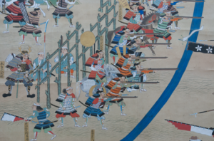 Edo-period six-fold painted screen showing the Battle of Nagashino with Nobunagas palisade defense and the Takeda cavalry charges against it