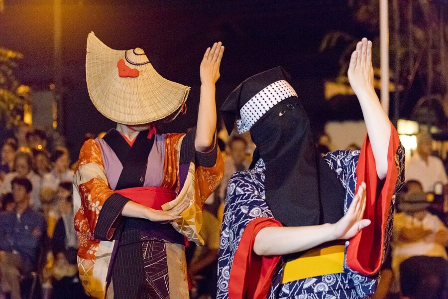 Nishimonai Bon Odori dancers in patchwork hanui with hikosan-zukin black face coverings, Akita prefecture