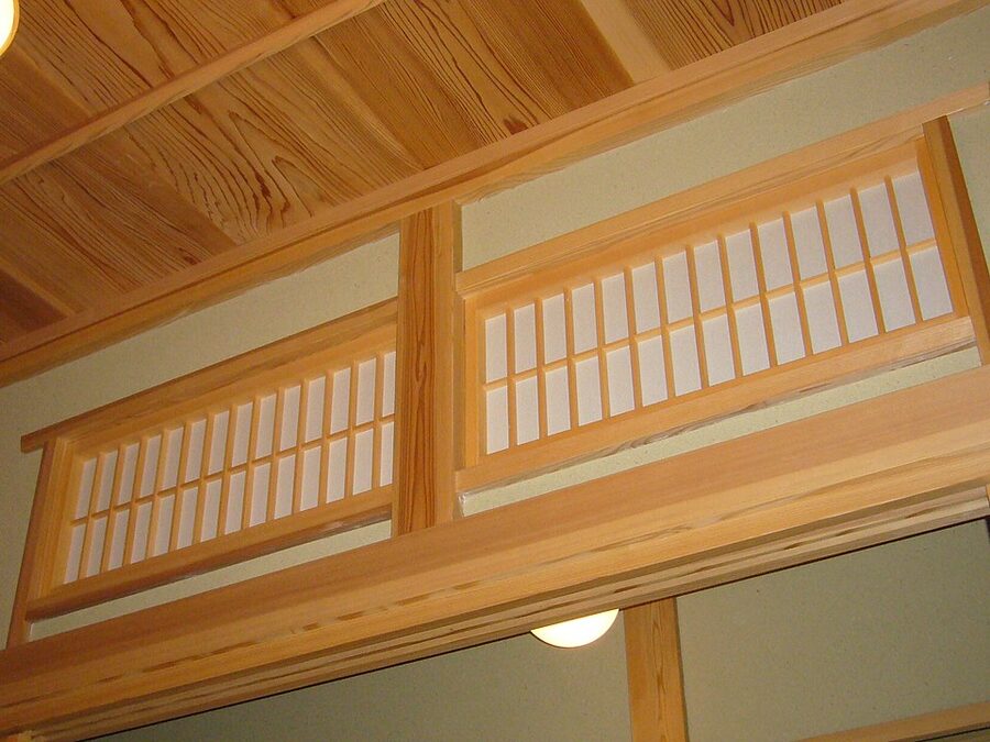 Close-up detail of a carved wooden ranma transom above paper-covered fusuma sliding doors in Katori city Chiba