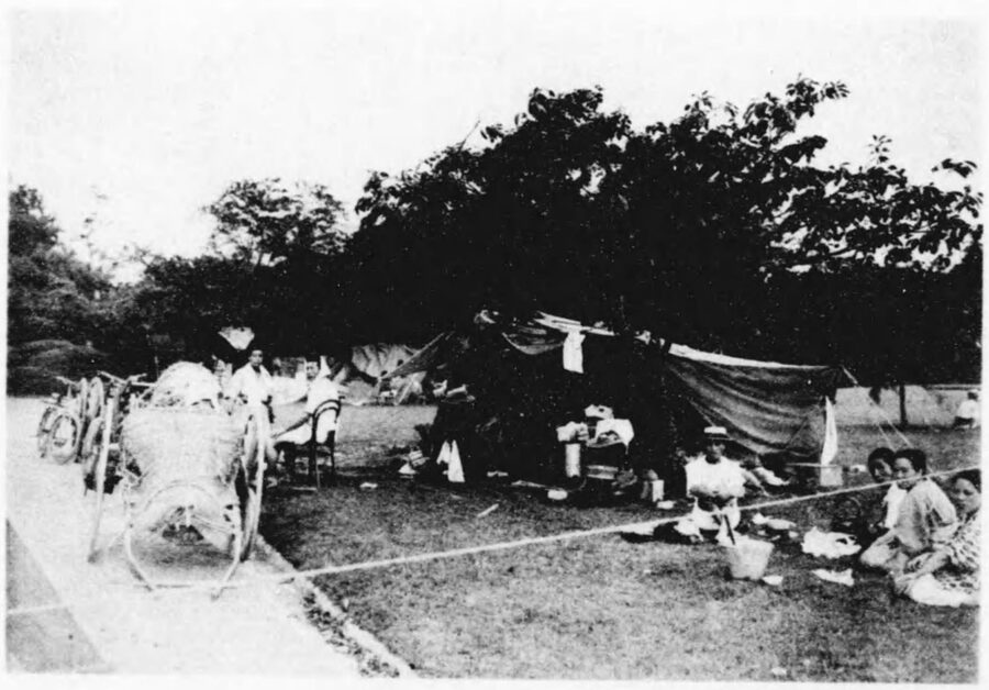 Black-and-white photograph of refugee tents pitched in Shinjuku Gyoen national gardens after the 1923 Great Kanto earthquake