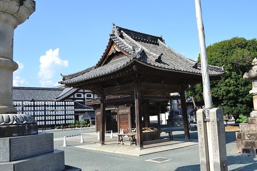 Dense cluster of stone fox statues at Reiko-zuka grotto
