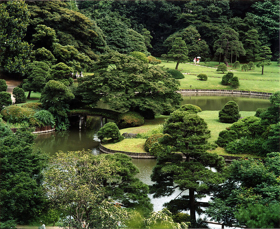 Pond, stone lantern and pine trees at Rikugien stroll garden in Tokyo