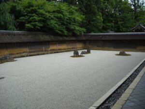Closer view of a rock grouping and raked concentric ripple patterns at Ryoanji rock garden
