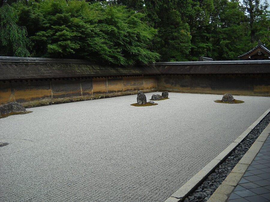 Closer view of a rock grouping and raked concentric ripple patterns at Ryoanji rock garden