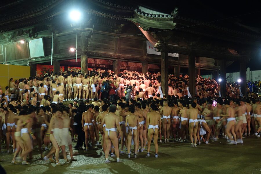 Participants in white fundoshi loincloths inside Saidai-ji during Eyo Hadaka Matsuri