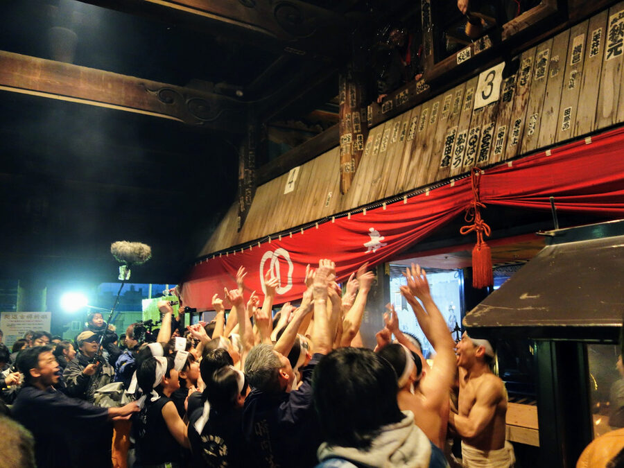 Water splashed with ladle and ofuda amulets thrown from Ofuku-mado window during Saidaiji Eyo