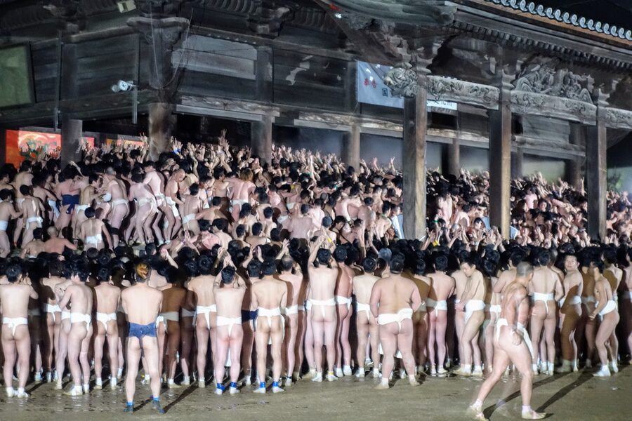 Crowd of fundoshi-clad participants packed inside the Main Hall of Saidai-ji during Hadaka Matsuri