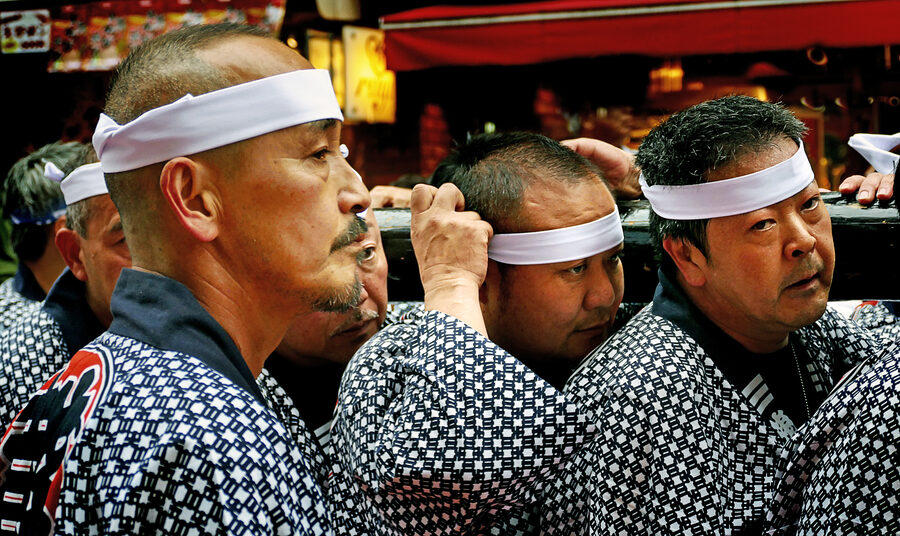 Sanja Matsuri bearers in matching happi coats representing Asakusa town associations