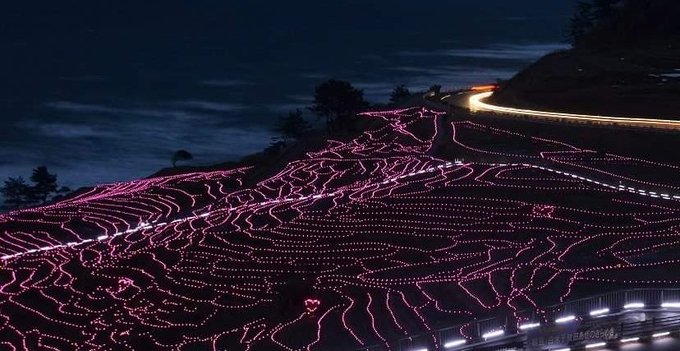 Senmaida rice terraces illuminated with thousands of solar LED lights at night