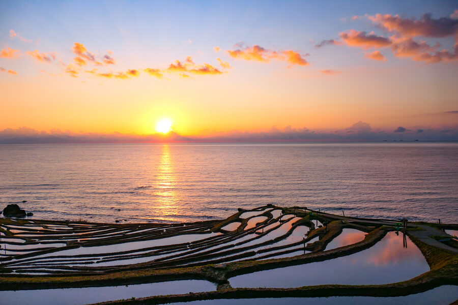 Senmaida rice terraces glowing at sunset above the Sea of Japan
