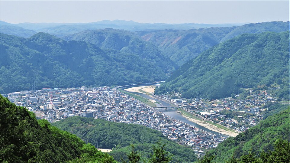 Takahashi city old samurai district Ishibiya with surviving Edo-period wooden merchant houses walled gardens and narrow streets below the castle on Mount Gagyu