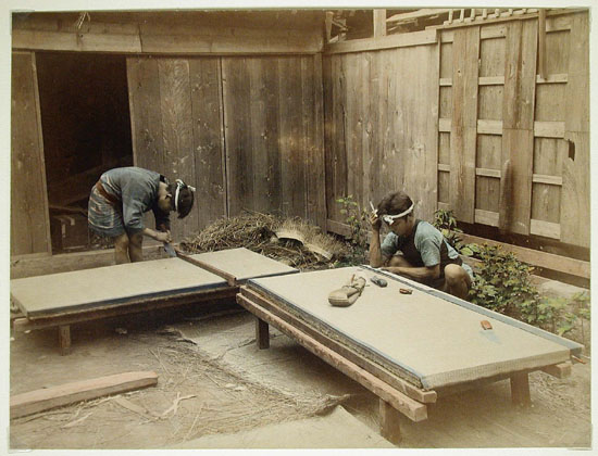 Late 19th-century photograph of men making tatami mats by hand showing traditional cross-legged workspace and igusa rush sewing