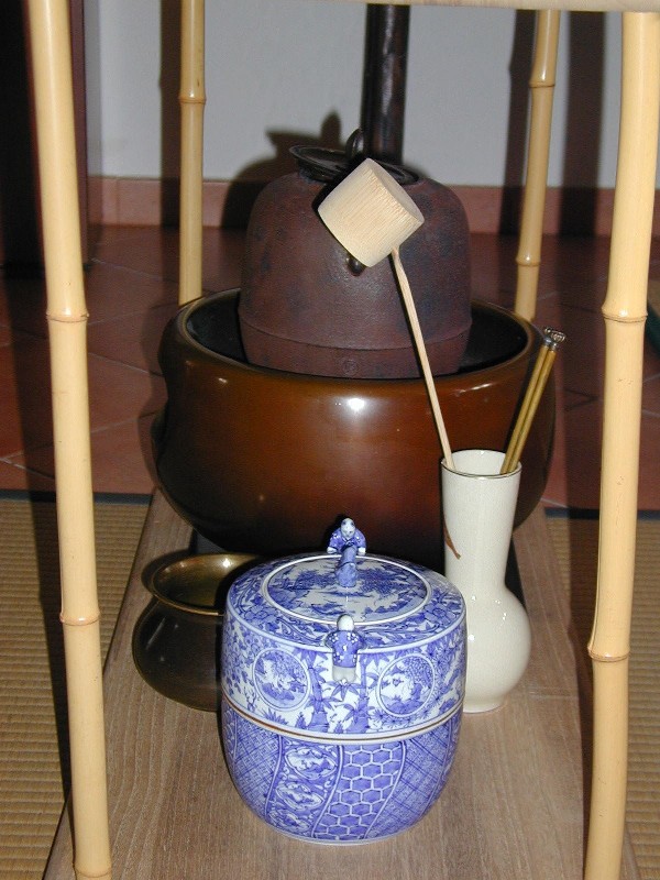 A formal daisu stand for tea ceremony displaying the full array of utensils used in a chaji tea service