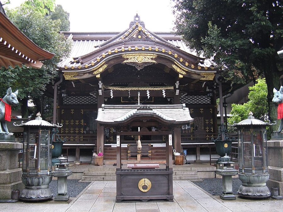 Tokyo branch Toyokawa Inari Honden hall with red lanterns and wooden facade