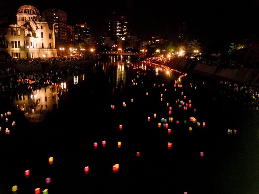Toro nagashi paper lanterns drifting down the Motoyasu river in Hiroshima during August Bon week