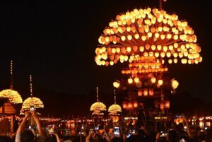 Makiwarabune ceremonial boat carrying over 500 illuminated paper lanterns drifting across Maruike pond during the Yoimatsuri of the Owari Tsushima Tennō Matsuri