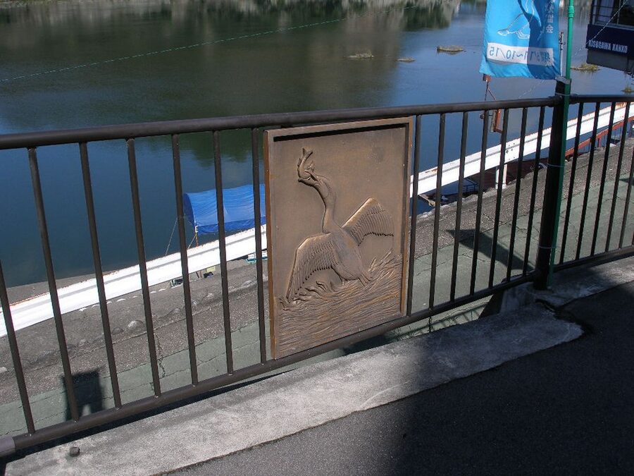 Ukai cormorant fishing boat with three crew members and burning torch on the Kiso River at Inuyama, Aichi Prefecture, seen at night