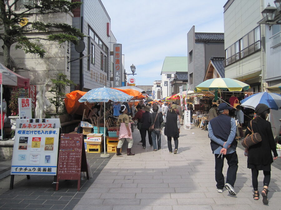 Tarpaulin-covered Wajima Asaichi morning market stalls along the street