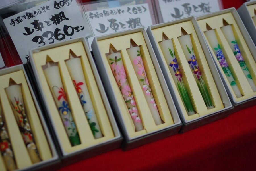 Lit warousoku Japanese candles in a row showing the characteristic large steady flame that distinguishes them from paraffin candles