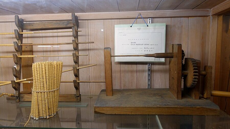 Traditional candle wick-making machinery preserved at Hirata Folk Art Museum Takayama showing rush-and-washi wick production