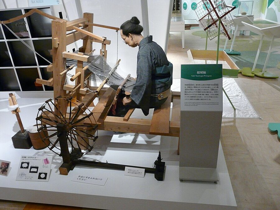 Yokohama Silk Museum display showing Nishijin-ori handwoven Japanese silk fabric with traditional loom equipment