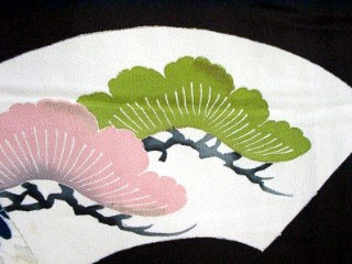 Traditional yuzen dyeing technique applying pigment to resist-paste outlines on silk kimono cloth by Kyoto artisan